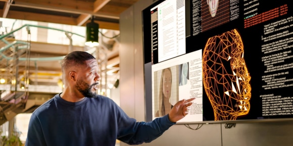 Man working with AI on computer
