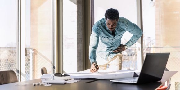 Man looking at a blueprint