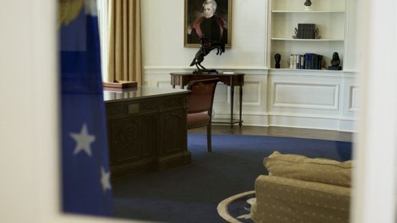 Interior of a formal room with US flag and podium setting