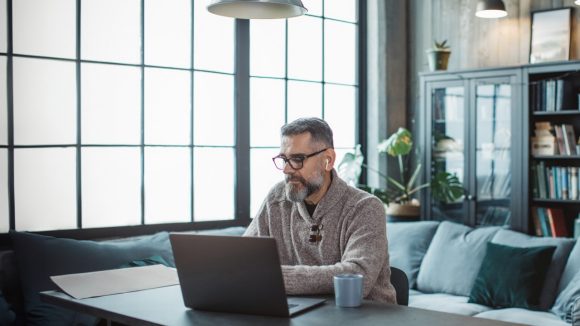 Man in home office on laptop