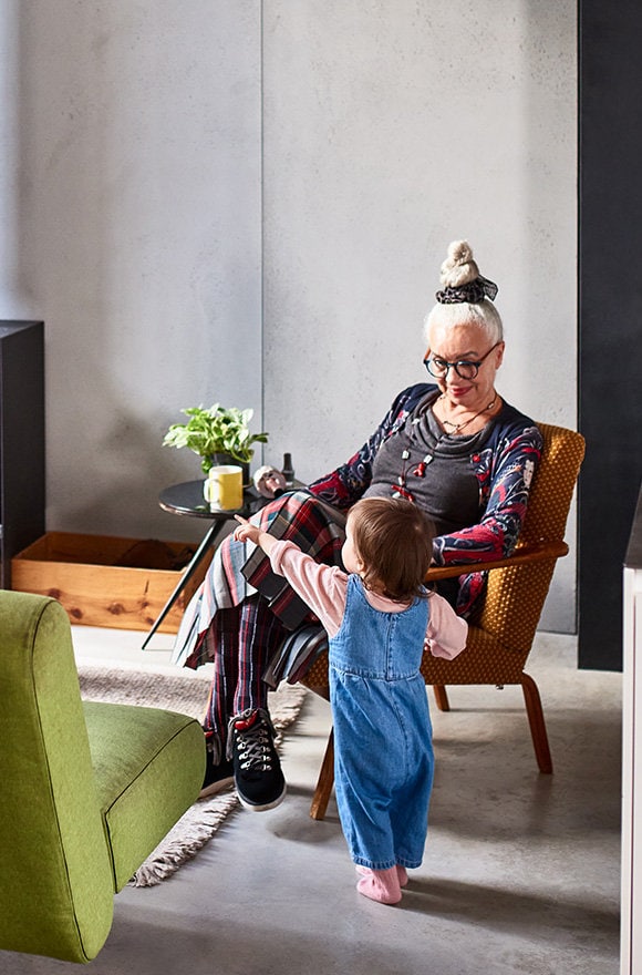 Grandmother with grandchild in home.