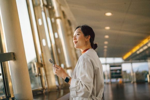 Woman with cell phone in airport