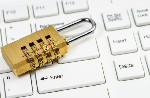 Photograph: Small padlock sitting on top of a computer keyboard