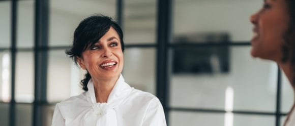 colleagues simling at each other