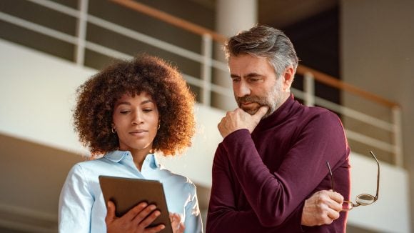 business people looking at tablet