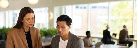 two professionals discussing finances in an office