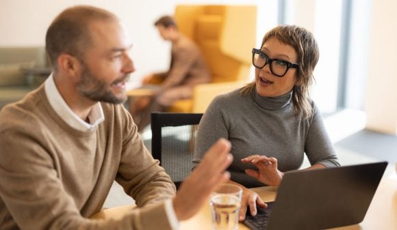 Two proffessionals discussing in office about finance