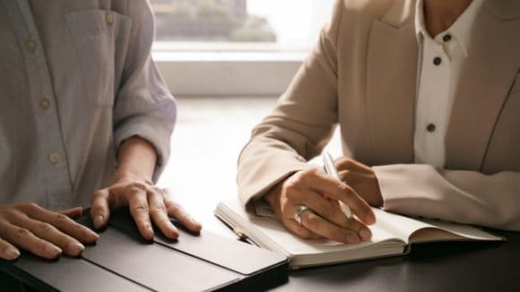 Women with tablet and notebook