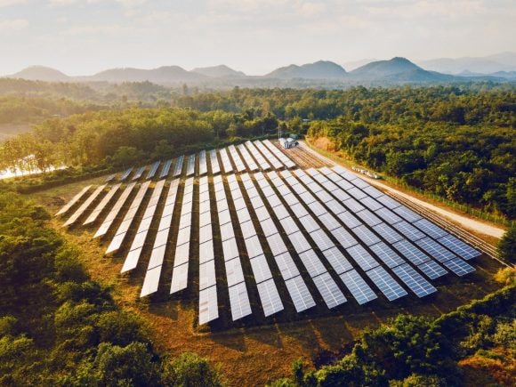 Aerial view of solar panels with mountains in background