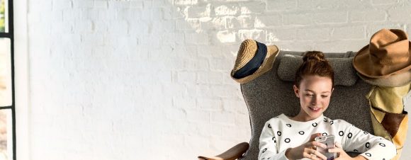 Teenage girl smiling on iphone