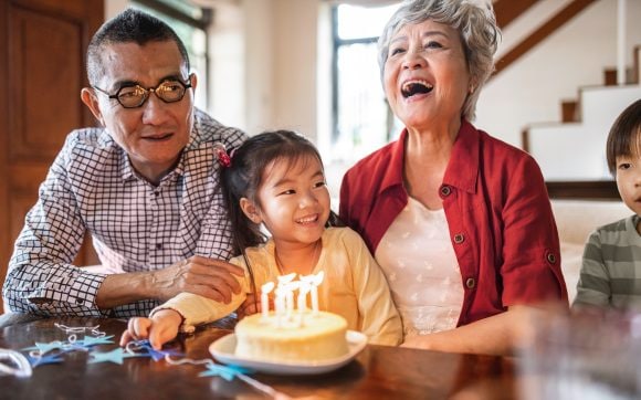Grandparents celebrating birthday of granddaughter