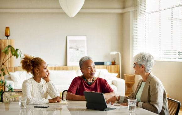 Senior woman and daughter listening to client advisor
