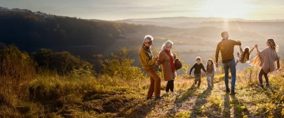 Multi-generation family having walk on their mountainside estate.