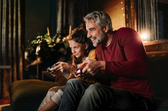 Father playing video game with daughter
