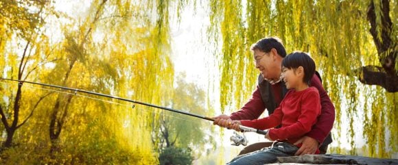 Grandfather and grandson fishing together