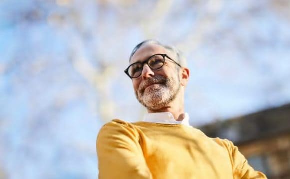 Happy adult man smiling on a bright sunny day