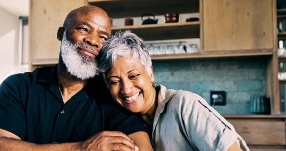 Content elderly couple embrace in kitchen