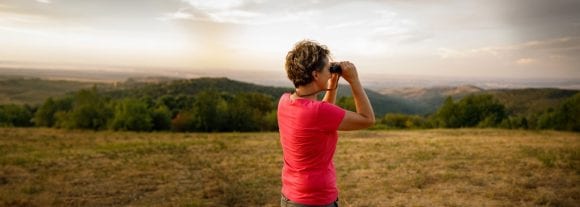 women seeing through binoculars