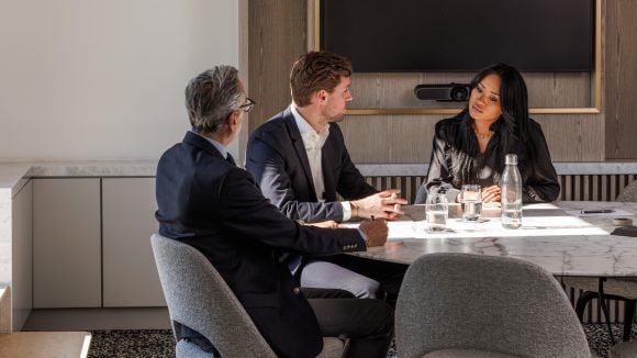 Three people having meeting in conference room
