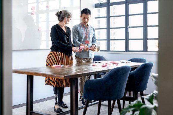 Woman problem solving with male colleague.