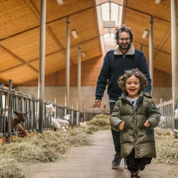 Father and child in barn