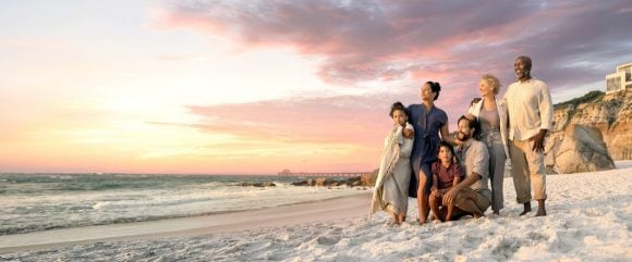 Multiple generations of family enjoying sunset on beach
