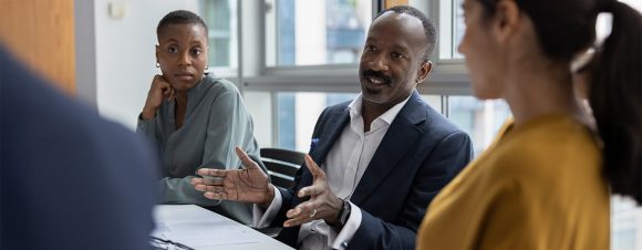 Mature businessman leading a corporate business office meeting