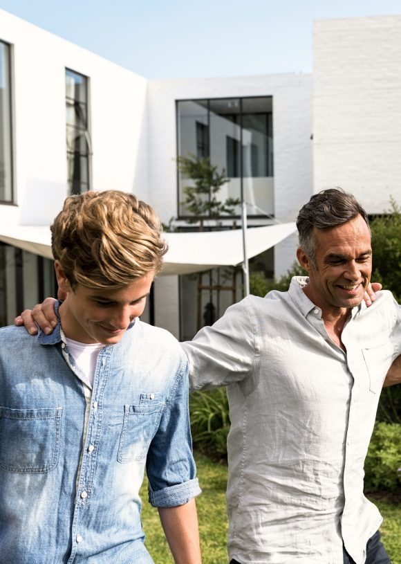 Father son and grandfather walking in the garden Three generation family