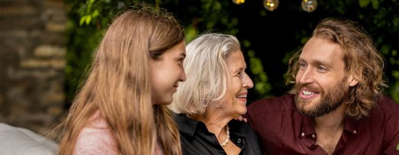 Grandmother, son and granddaughter in garden