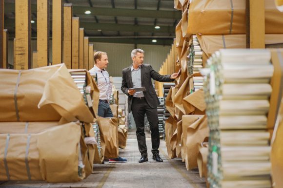 Two business people in warehouse