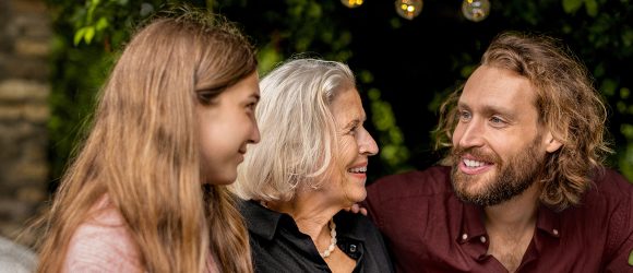 Grandmother, son and granddaughter in garden
