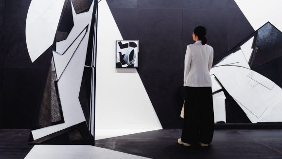 Women looking at art on wall