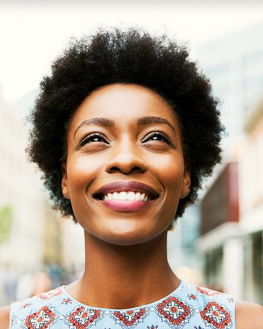 Close-up of optimistic woman smiling outdoors