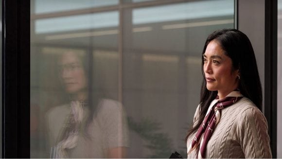 Close-up of woman looking out office window