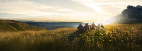 Aerial view of family looking towards sunrise.