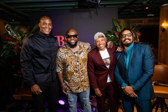 Panelists Rico Love, Kevin Liles, Rohan Marley and Wale Ogunleye smiling at camera