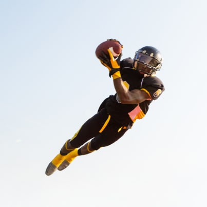 Image of a football player making a diving catch