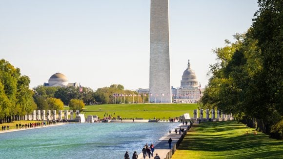 Shot of the Washington, D.C. monument with American Flags