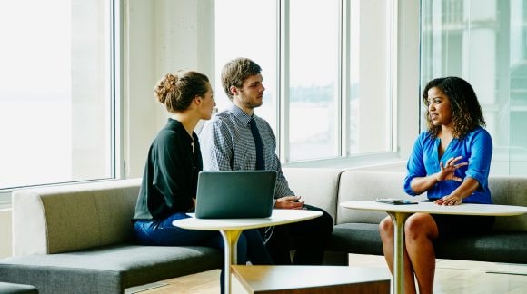 Businesswoman leading meeting with colleagues