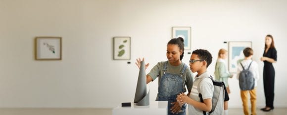 School age children looking at a sculpture at a museum