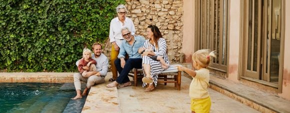 Multigenerational family enjoying time together poolside